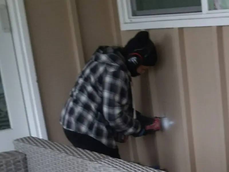Professional electrician installing an exterior outlet in Lyon